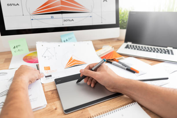 istock Graphic designer drawing sketches logo design. 1247164588