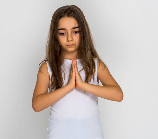 istock Young girl praying 1247165689