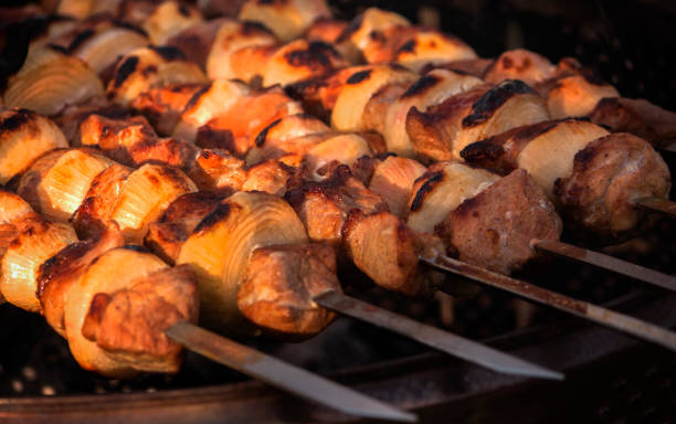 istock meat on skewers is fried on coals at sunset close up 1247176967