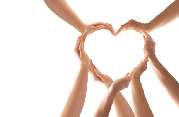 The concept of unity, cooperation, teamwork and charity. Symbol and shape of heart created from hands.The concept of unity, cooperation, partnership, teamwork and charity. hands forming heart shape stock pictures, royalty-free photos & images
