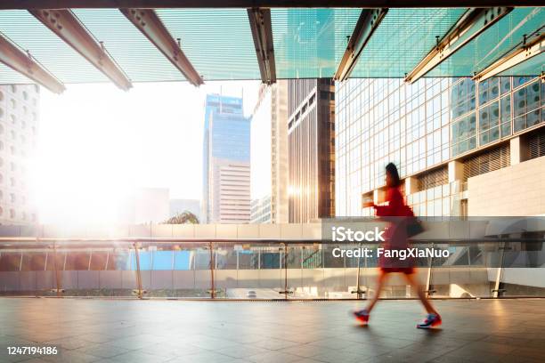 Blurred Motion Businesswoman Walking At Pedestrian Walkway At Dawn Stock Photo - Download Image Now
