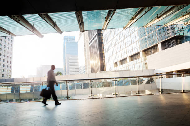 istock Blurred motion unrecognizable businessman walking at footbridge 1247194941
