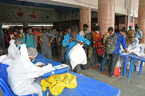Burdwan Town, Purba Bardhaman District, West Bengal / India - 06.06.2020: The migrant workers returning to home state (West Bengal) on the 'Shramik Special' Train from other states are undergoing health screening for Novel Coronavirus (COVID-19) testing.
