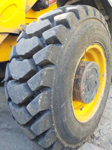 istock Orange tractor with huge wheels. Close up wheel. 1247197033