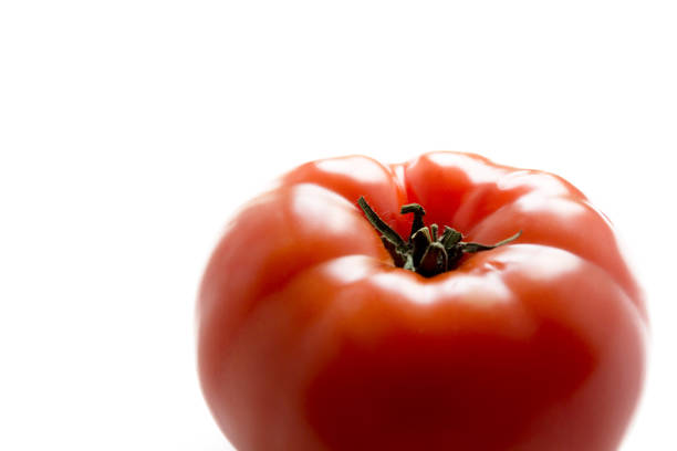 A ripe fresh red tomato isolated on white background, side view