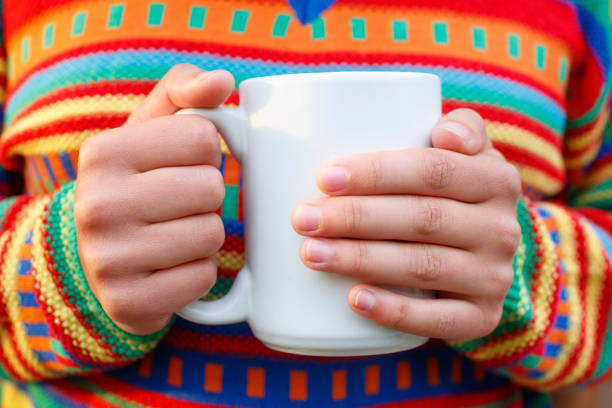 istock female hands holding a mug of hot beverage 1247218401