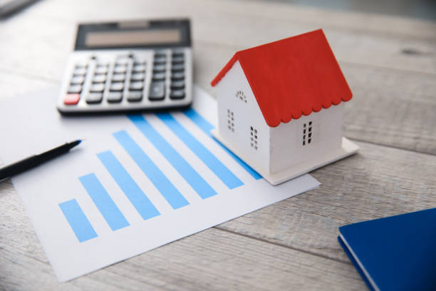 house model with calculator  on graph stock photo