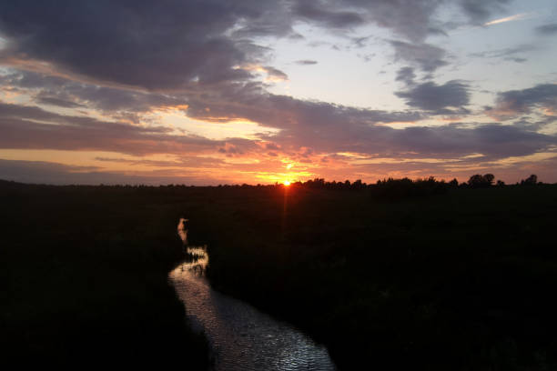 istock Beautiful landscape with a colorful sunset over the river 1247226378