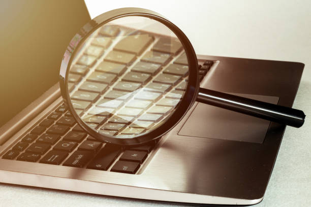 istock Laptop computer with magnifying glass, concept of search. 1247235430