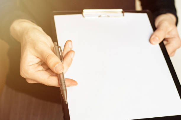 istock Pen and contract papers on wooden desk 1247235435