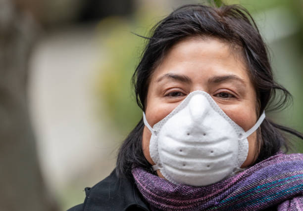 istock Hispanic Woman using wearing a real N95 protective mask 1247245792