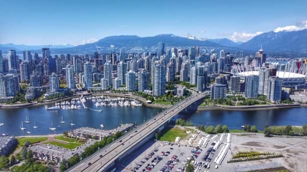 Aerial view of downtown Vancouver and Cambie bridge. A sunny mid 2020 aerial shot of downtown Vancouver, Yaletown, a marina, North Shore mountains, BC Place, False Creek and the Cambie bridge. british columbia stock pictures, royalty-free photos & images