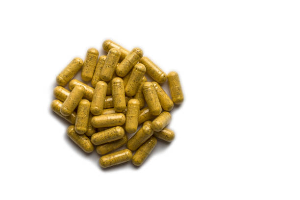 istock yellow pills on a white background 1247255519