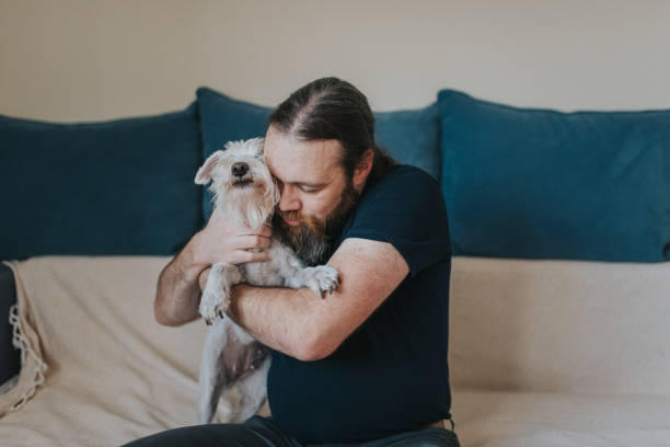 istock Pet owner is taking care and playing with his dog 1247272398