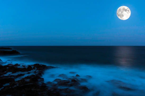 Moon over the Atlantic Ocean - Lanzarote, Canary Islands, Spain Moon over the Atlantic Ocean - Lanzarote, Canary Islands, Spain fantasy moonlight beach stock pictures, royalty-free photos & images
