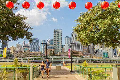 April 27. 2018 - Brisbane, Queensland, Australia: People enjoying a hot summer day in fall season, on back general view of Brisbane city with chinese lantern on Brisbane's Southbank, Queensland.