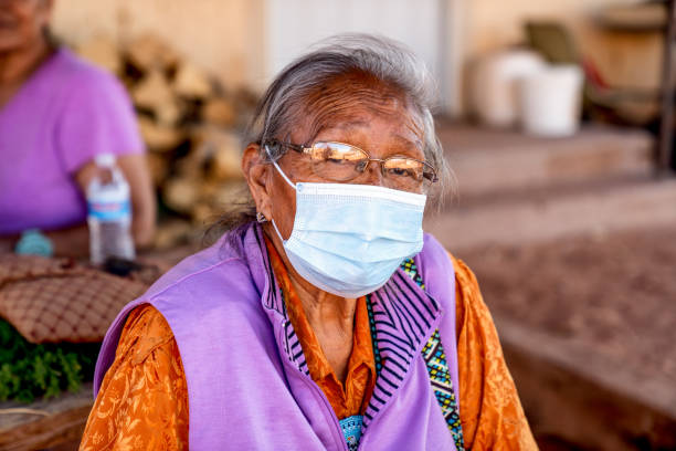 Aged Grandmother Navajo Woman Wearing a Mask to Prevent the Spread of the Corona Virus or Covi-19 Aged Grandmother Navajo Woman Wearing a Mask to Prevent the Spread of the Corona Virus or Covi-19 hopi culture photos stock pictures, royalty-free photos & images