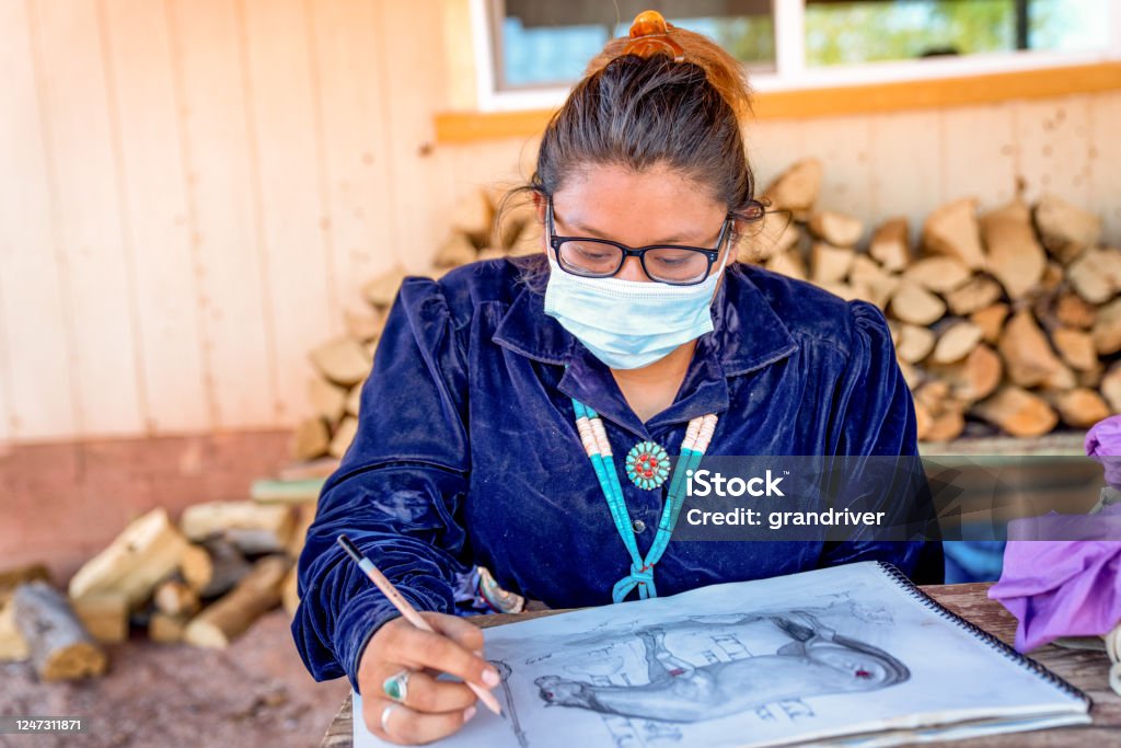 Young Teenage Navajo Girl Drawing a Picture while Wearing a Covi-19 Mask Healthcare And Medicine Stock Photo