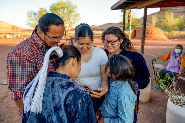 Navajo Family Spending Time Sharing Photos from a Smart Phone Navajo Family Spending Time Sharing Photos from a Smart Phone navajo nation covid stock pictures, royalty-free photos & images