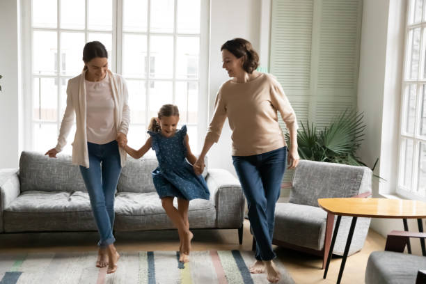 istock Energetic three generations of women dancing at home 1247334276