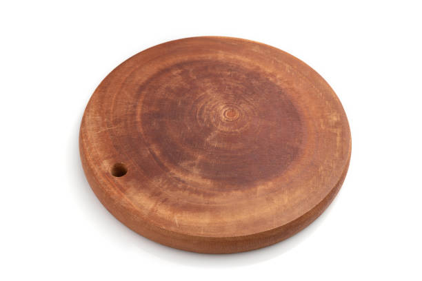 istock Wooden round cutting board isolated on white background. Side view, close up. 1247335658