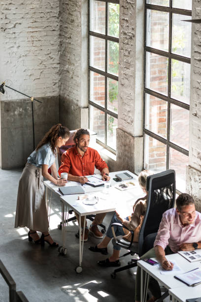 istock Wide Angle View of a Modern Loft Open Space Office With Businesspeople Working in It 1247371834