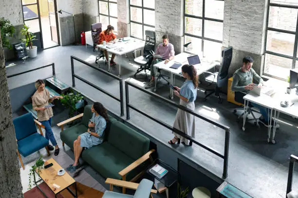 Photo of Wide Angle View of a Modern Loft Open Space Office With Businesspeople Working in It