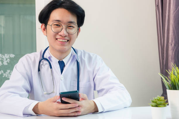 istock Doctor woman smiling using working with smart mobile phone 1247374614