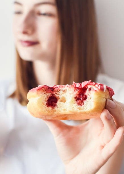 Close up portrait of a girl eating donuts