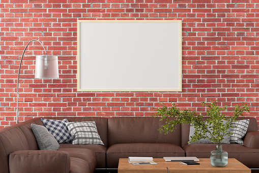 Blank horizontal poster frame on red brick wall in interior of living room with clipping path around poster. 3d illustration