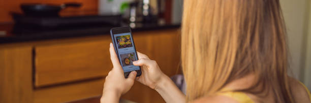 istock Young woman orders food for lunch online using a smartphone BANNER, LONG FORMAT 1247429109