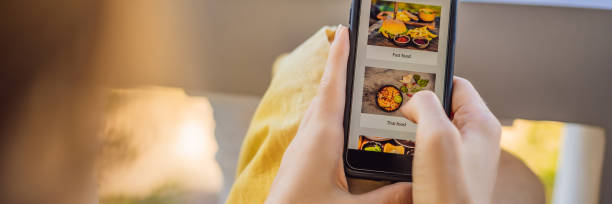 istock Young woman orders food for lunch online using a smartphone BANNER, LONG FORMAT 1247429115