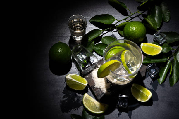 istock Caipirinha typical Brazilian drink with cachaca, lemon and sugar on dark background. Top view 1247505878