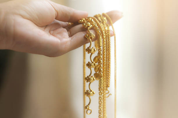 istock Hand Holding Gold Necklace 1247522522