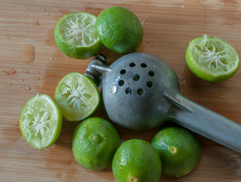 Macro photography with the concept of lemon squeezed on a cutting board with a lemon squeezer