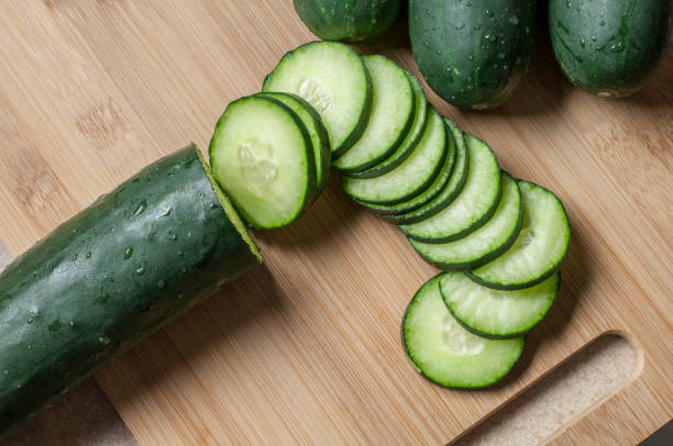 Cucumber Fresh cucumber slices on a wooden cutting board cucumber photos stock pictures, royalty-free photos & images