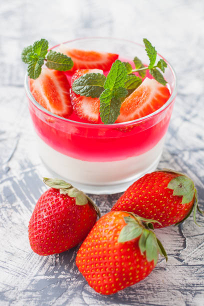 istock cottage cheese and berry jelly in a glass on a table, selective focus 1247544164