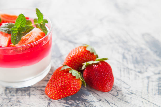 istock cottage cheese and berry jelly in a glass on a table, selective focus 1247544167