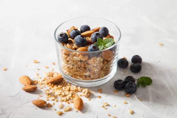 istock muesli with almonds and blueberry in a glass on a table, selective focus 1247547853