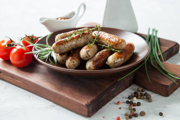 istock sausages and vegetables on a table, selective focus 1247550490