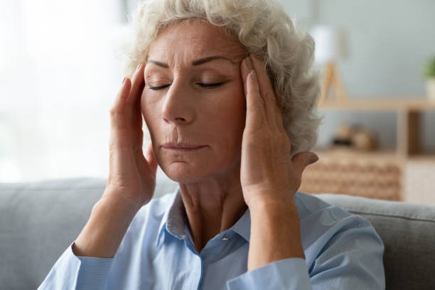 istock Closeup elderly woman massaging temples reduces intense headache 1247568821