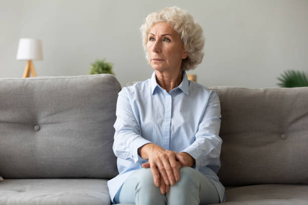 istock Pensive elderly woman looking away lost in her thoughts 1247568823