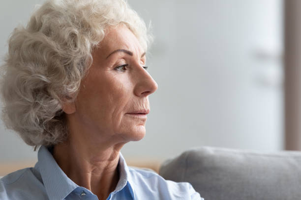 istock Pensive serious old woman face profile closeup view 1247568832