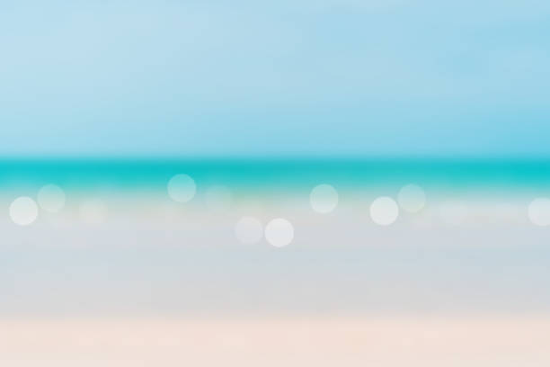 istock Blur summer bokeh beach with sun light and blue sky background. 1247601762