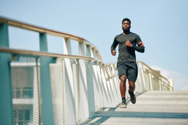 istock Sportsman jogging on bridge 1247604916