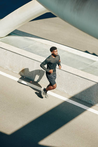 istock Sportsman running along the road 1247604935