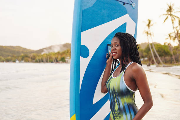istock Woman with sup board looking at sea 1247604972
