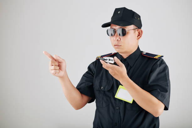 istock Policeman using police radio 1247607155