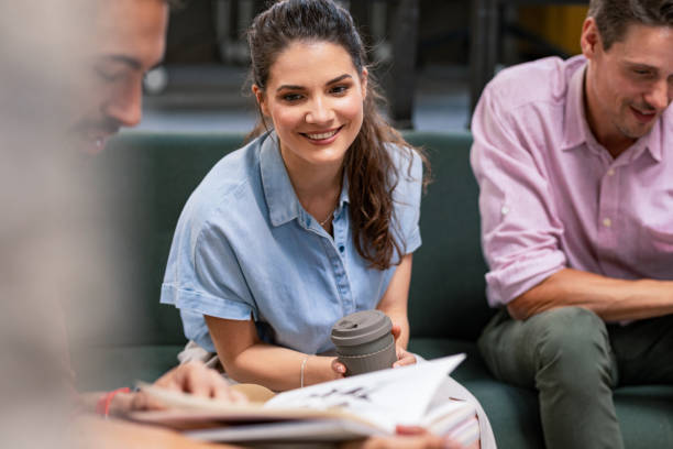 istock Pretty Businesswoman Chatting With Co-Workers 1247610014