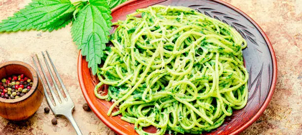 Italian traditional pasta with green nettle sauce.